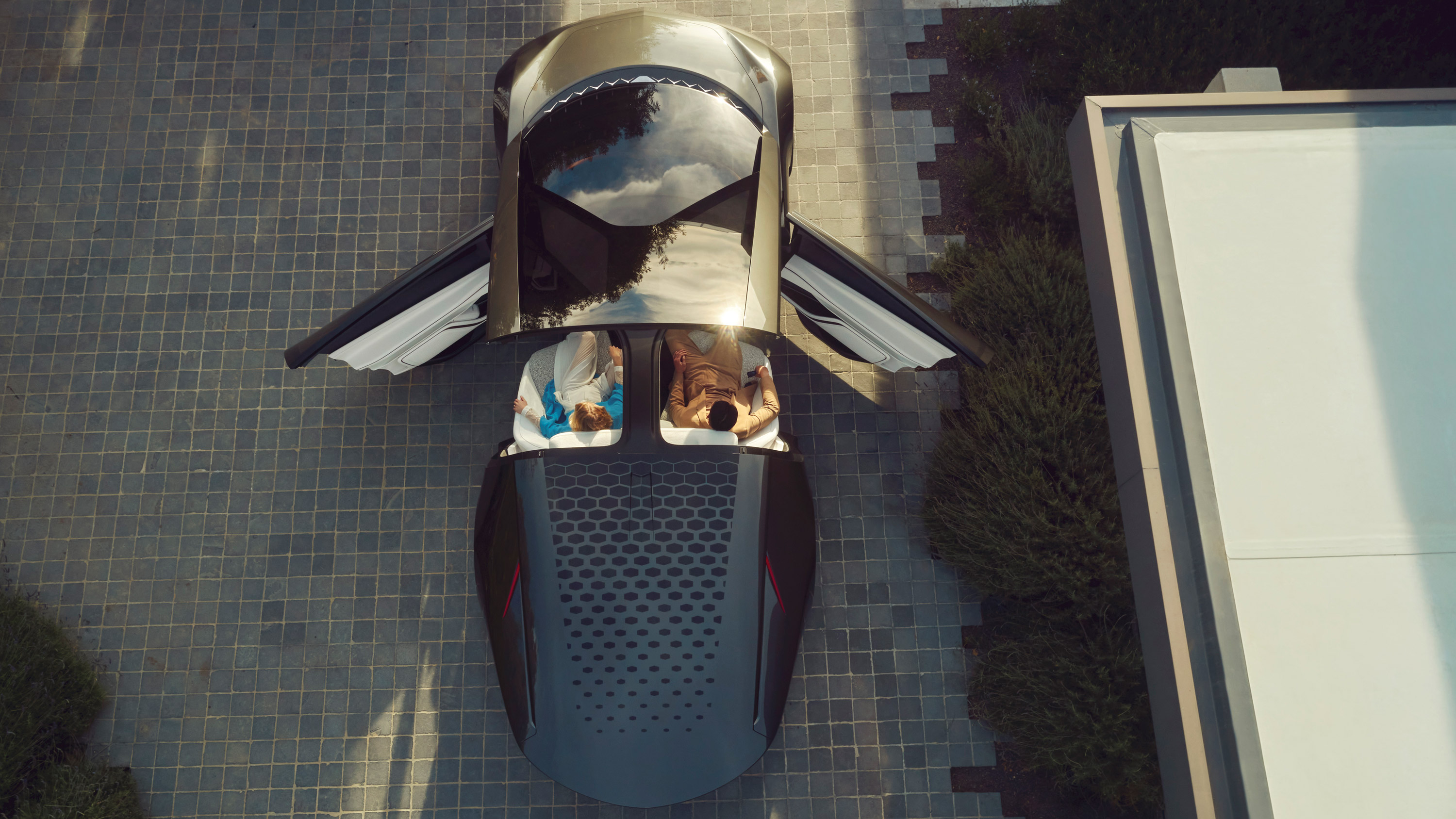 Top-down view of man and woman sitting in Cadillac InnerSpace concept with doors open