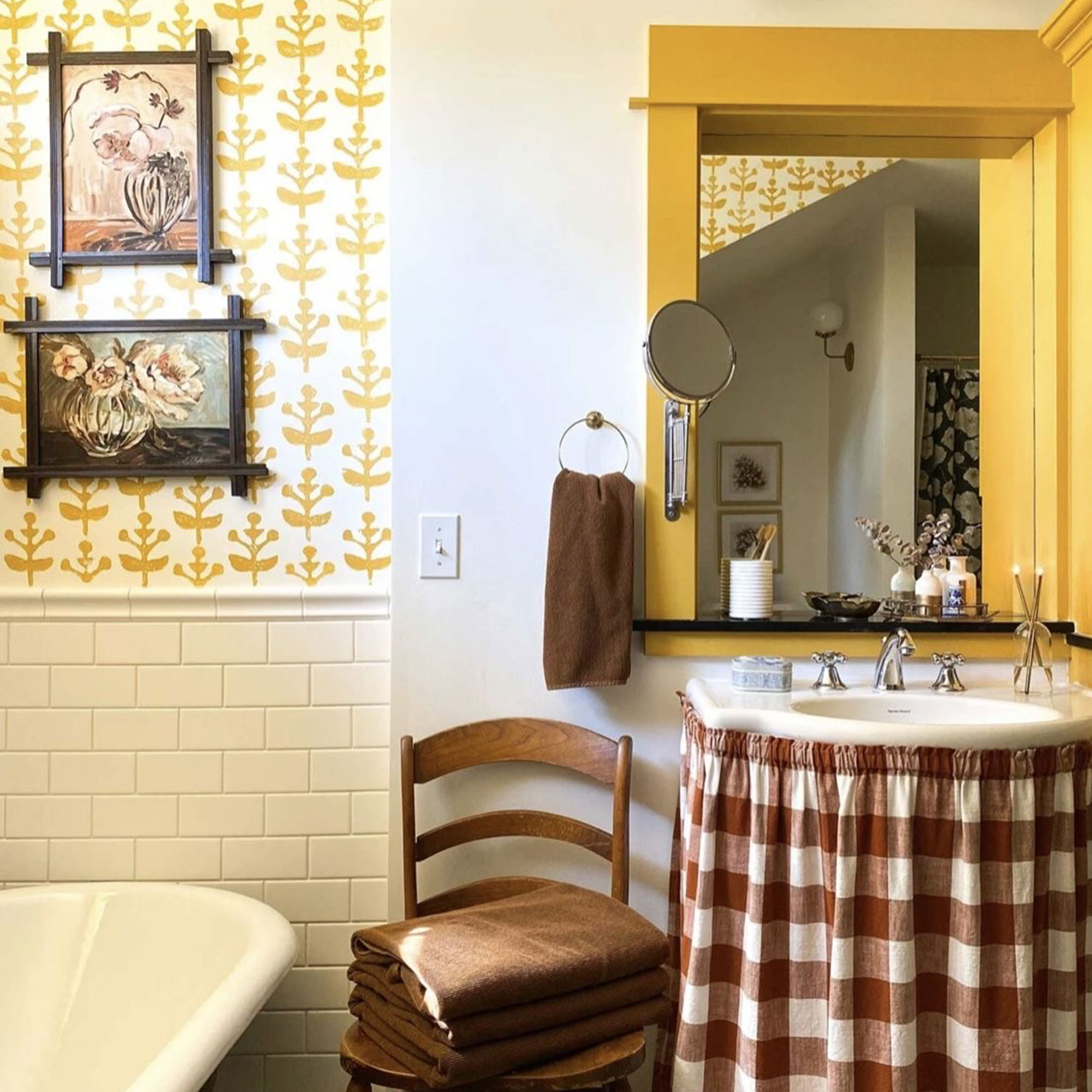 Bathroom with wooden yellow trim around mirror and gingham sink skirt underneath basin