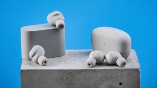 Sony WF-1000XM6 earbuds photographed in front of a blue background