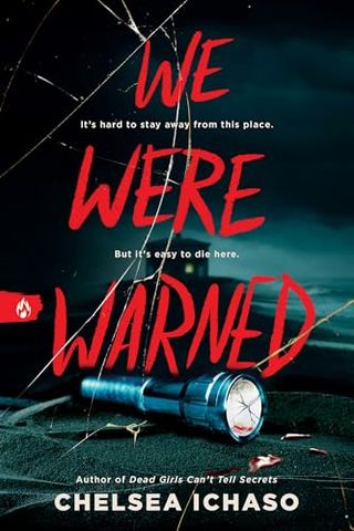 'We Were Warned' book cover with a cracked glass like design and a flashlight on the ground