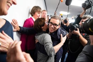 Jens Soering, who served 33 years in prison for a double murder, is hugged by supporters as he arrives for a press conference after arriving in Germany following his extradition from the US after receiving a partial pardon, on December 17, 2019