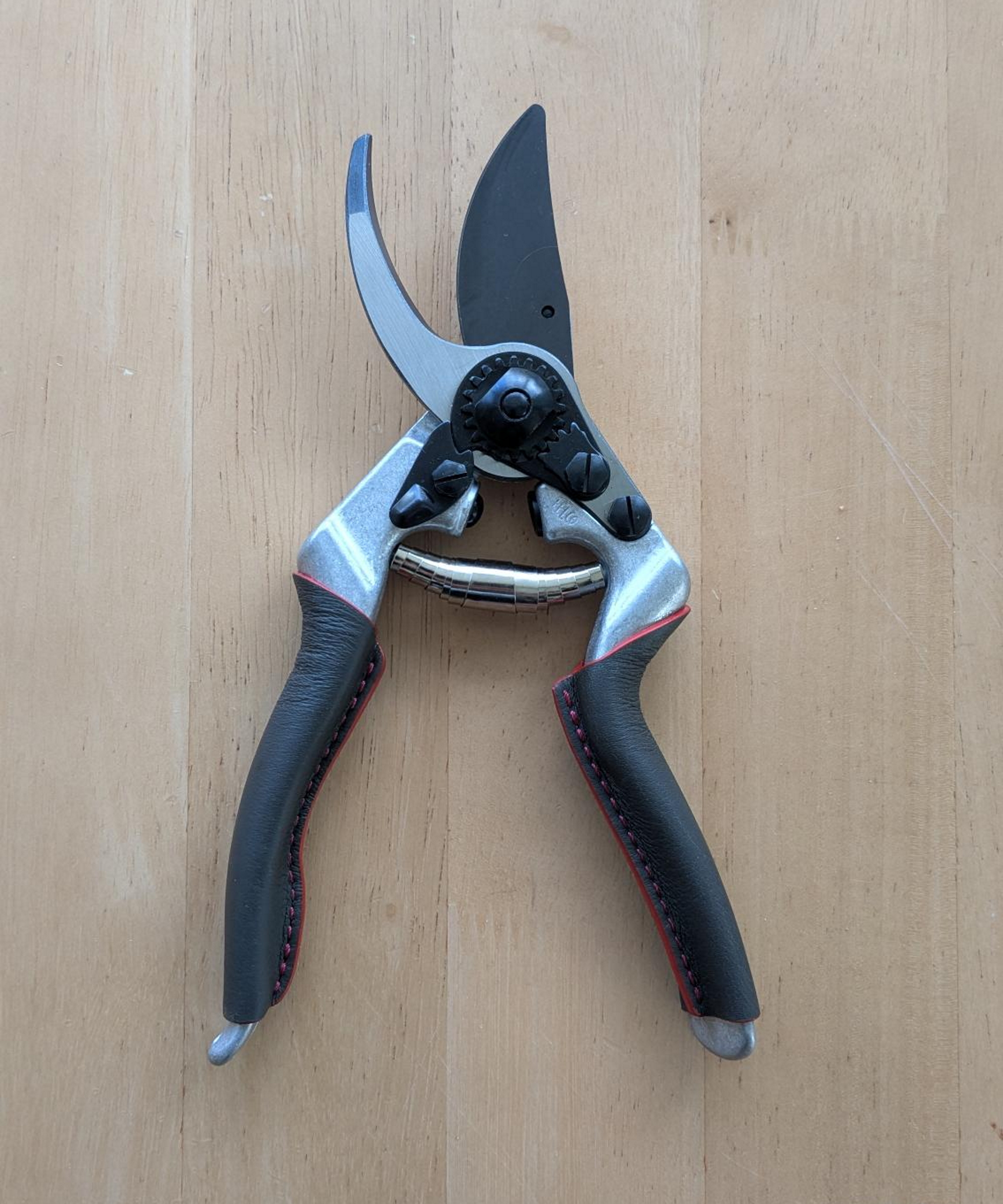A pair of Felco 8 Elite pruning shears on a wooden table