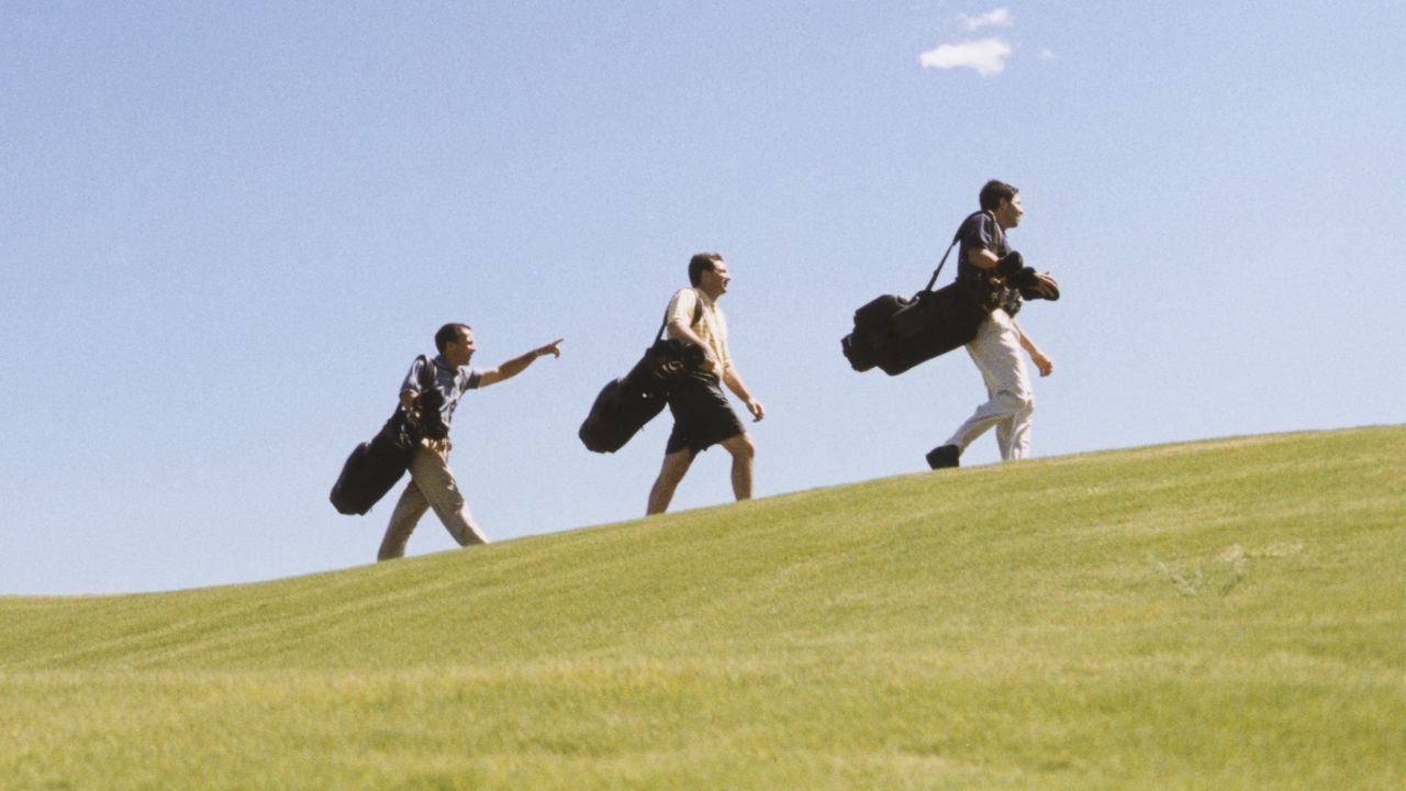 Golfers walking up an incline GettyImages-6524-000485