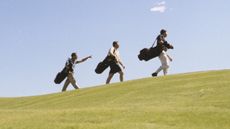 Golfers walking up an incline GettyImages-6524-000485