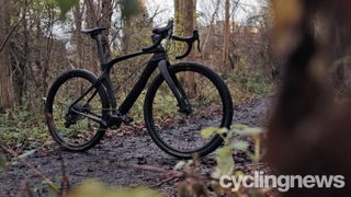 A Pinarello Grevil in black on a woodland trail