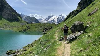 Hiking towards a cabin on a lake in the Swiss Alps