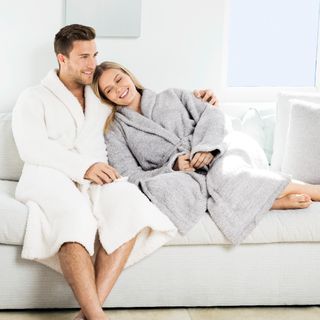 Barefoot Dreams cozychic bathrobe couple on sofa