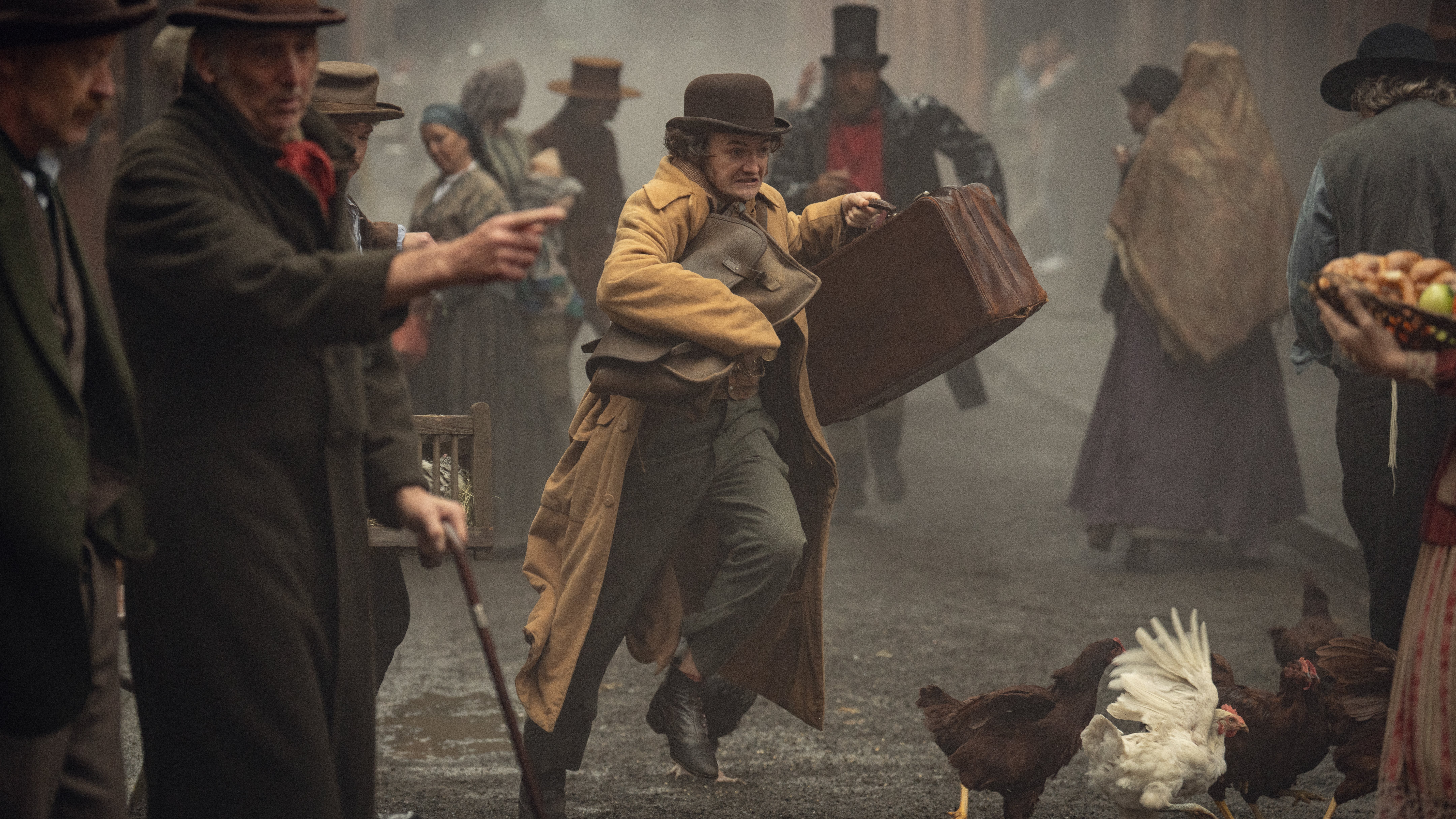 A first-look photo from Netflix's "House of Guinness" showing a figure running through the streets holding a briefcase