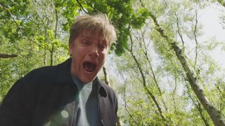 Robert looks over the cliff's edge and sees Aaron and John's lifeless bodies below