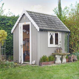 A garden shed surrounded by a lawn