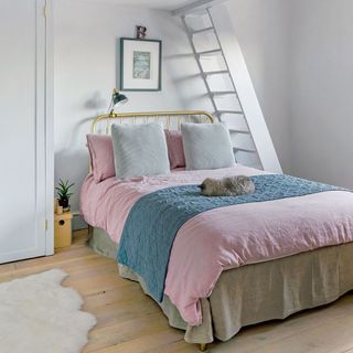 bedroom with white wall and pink bedlinen