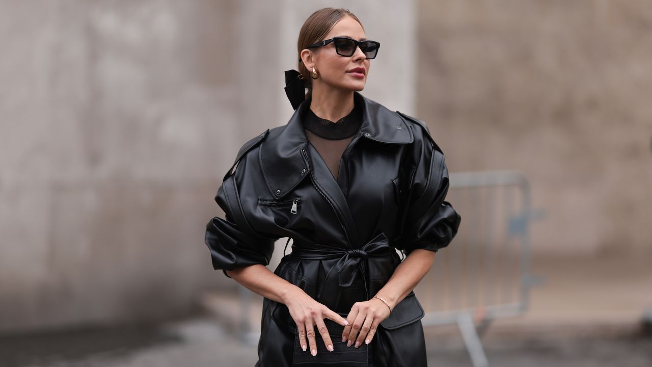 Woman wearing oversized bow, leather jacket and sunglasses with makeup using best matte foundations