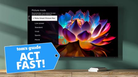 The Roku Pro Series, wall-mounted and displaying a colorful, neon-tinted flower. Next to the TV is a blue-colored badge that reads: "Tom's Guide Act Fast!"