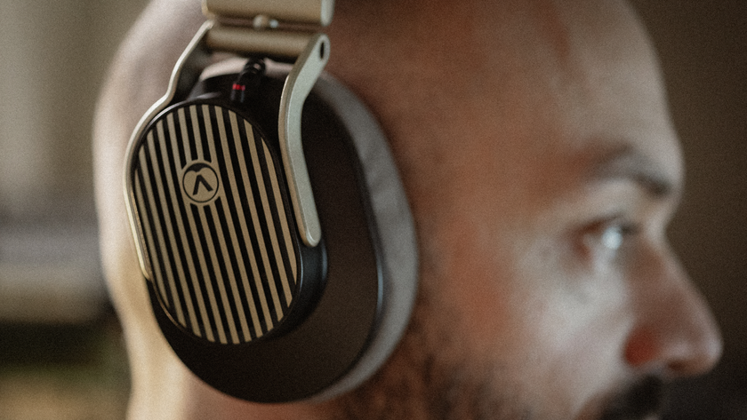 A close up photo of a bearded man wearing Austrian Audio The Arranger headphones