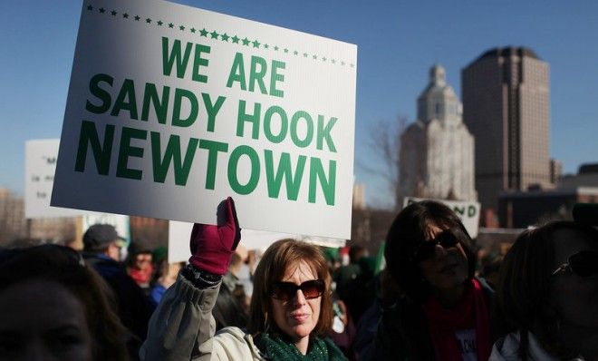 A woman holds up a sign during a Feb. 14 rally at the Connecticut State Capital to promote gun-control legislation.