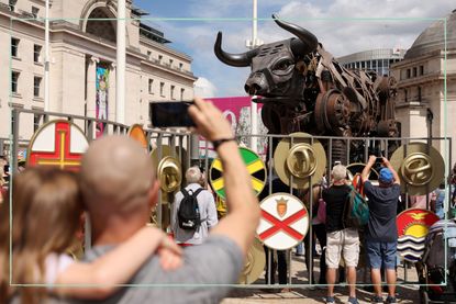 A crowd surrounding the Commonwealth Games bull in Centenary Square in Birmingham