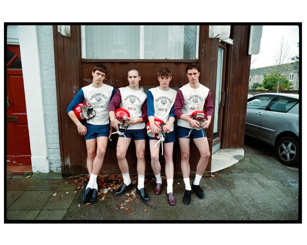 Four teenagers wearing American Footbal outfits.