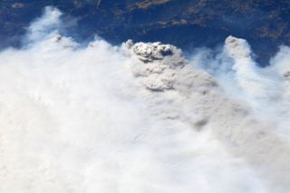 In an image NASA astronaut Chris Cassidy shared on Aug. 21, 2020, smoke billows above California, which is fighting more than 360 fires.