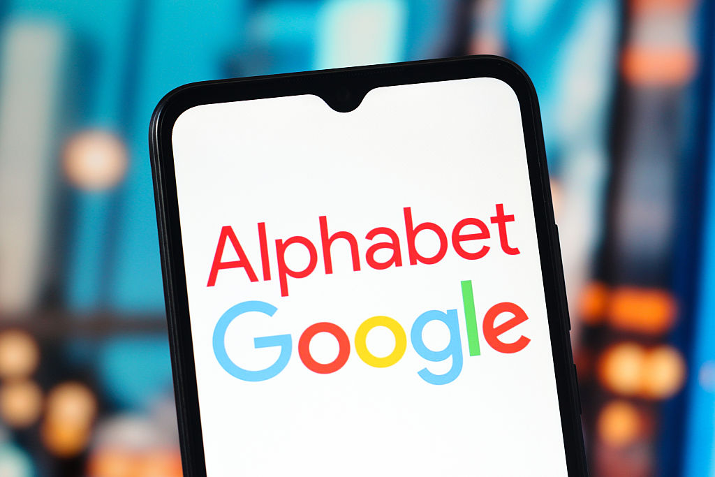 Alphabet and Google logo is seen displayed on a smartphone screen