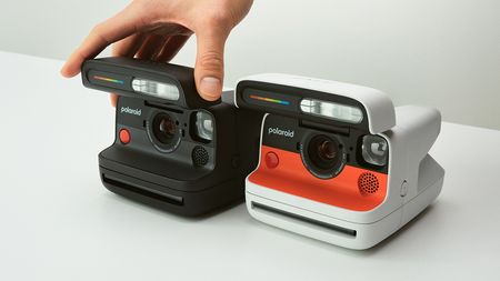 Black and white-and-orange Polaroid Flip cameras side by side
