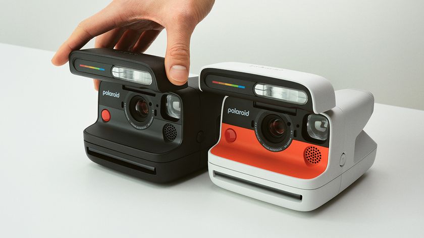 Black and white-and-orange Polaroid Flip cameras side by side