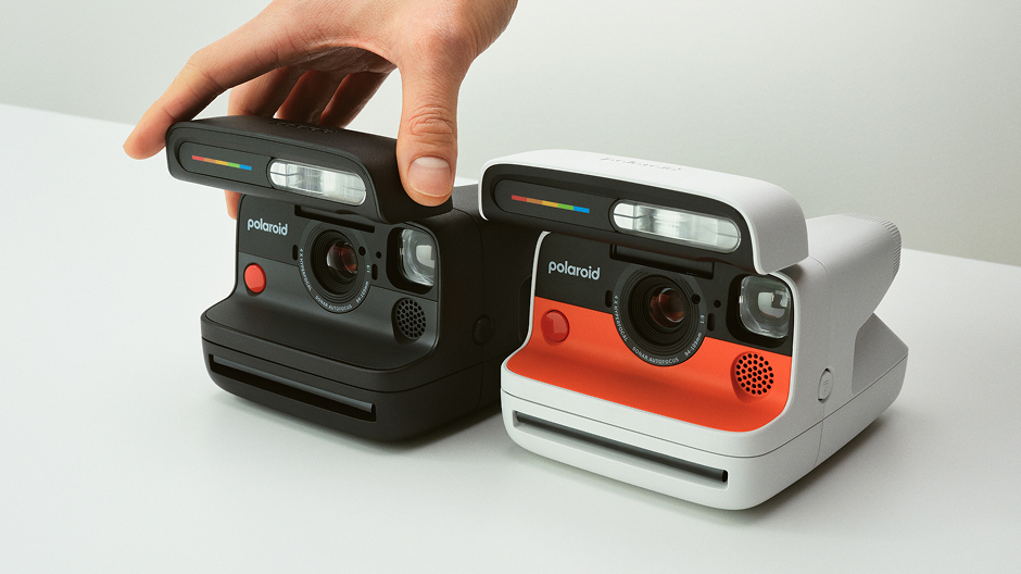 Black and white-and-orange Polaroid Flip cameras side by side