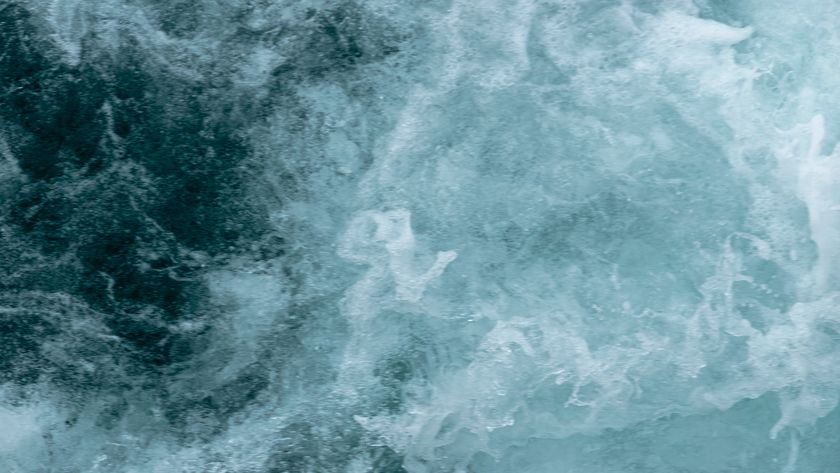 A swirl of blue and white shows ocean waves roiling in the water