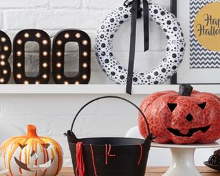 Halloween activities for kids including googly eye wreath, 'Boo' signage, drip painted pumpkin, papier mache pumpkin and black bucket