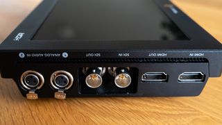 Close up of ports on a Blackmagic Video Assist 7 12G HDR video monitor on a wooden surface