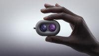 The DuRoBo Moodi in a model's hand, showing off its cute purple and pink emoji caps.
