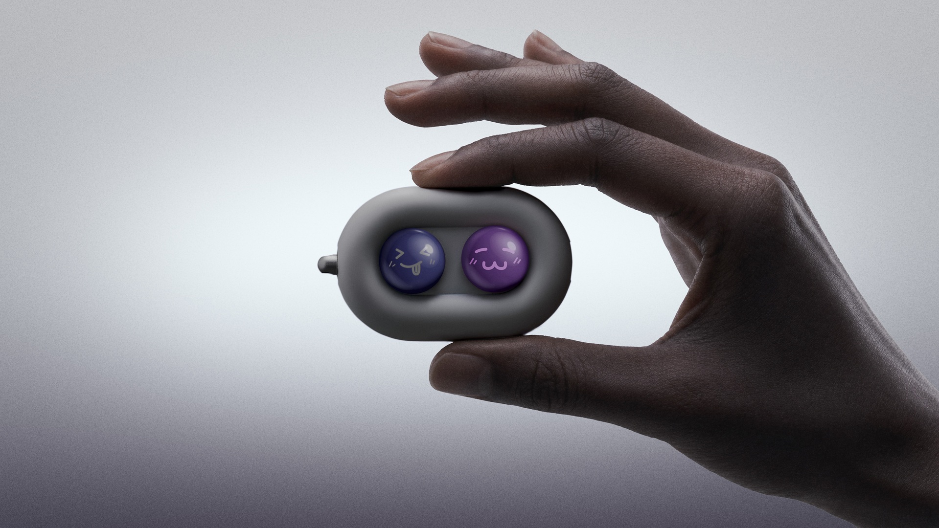 The DuRoBo Moodi in a model's hand, showing off its cute purple and pink emoji caps.