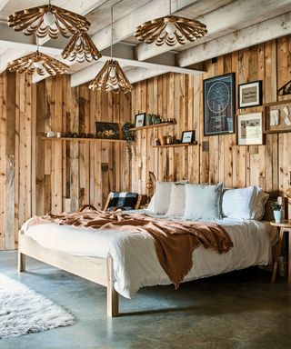 Rustic bedroom in lighting designer Tom Raffield's Cornish timber home