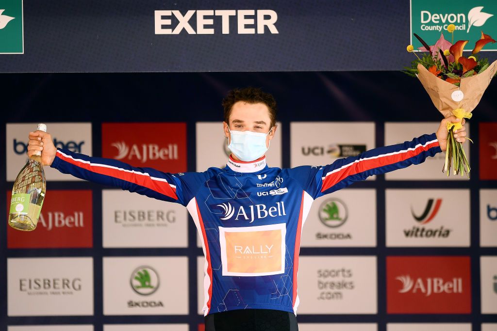 EXETER ENGLAND SEPTEMBER 06 Robin Carpenter of United States and Team Rally Cycling celebrates winning the blue leader jersey on the podium ceremony after the 17th Tour of Britain 2021 Stage 2 a 1839km stage from Sherford to Exeter TourofBritain TourofBritain on September 06 2021 in Exeter England Photo by Harry TrumpGetty Images