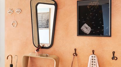 Modern orange small entryway with mirror and wall decor