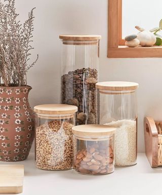 Dry foods in glass jars with wooden lids
