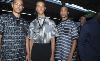 Three male models wearing patterned clothing by Givenchy in black and white.