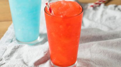 How to make a slushie in a blender - a red slushie in the foreground with a blue slushie in the background