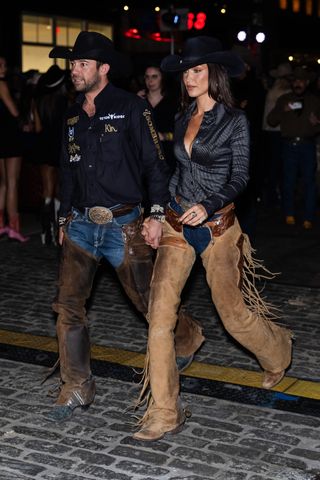 A photo of Bella Hadid and Adan Banuelos in brown leather chaps for a live horse-cutting demonstration.