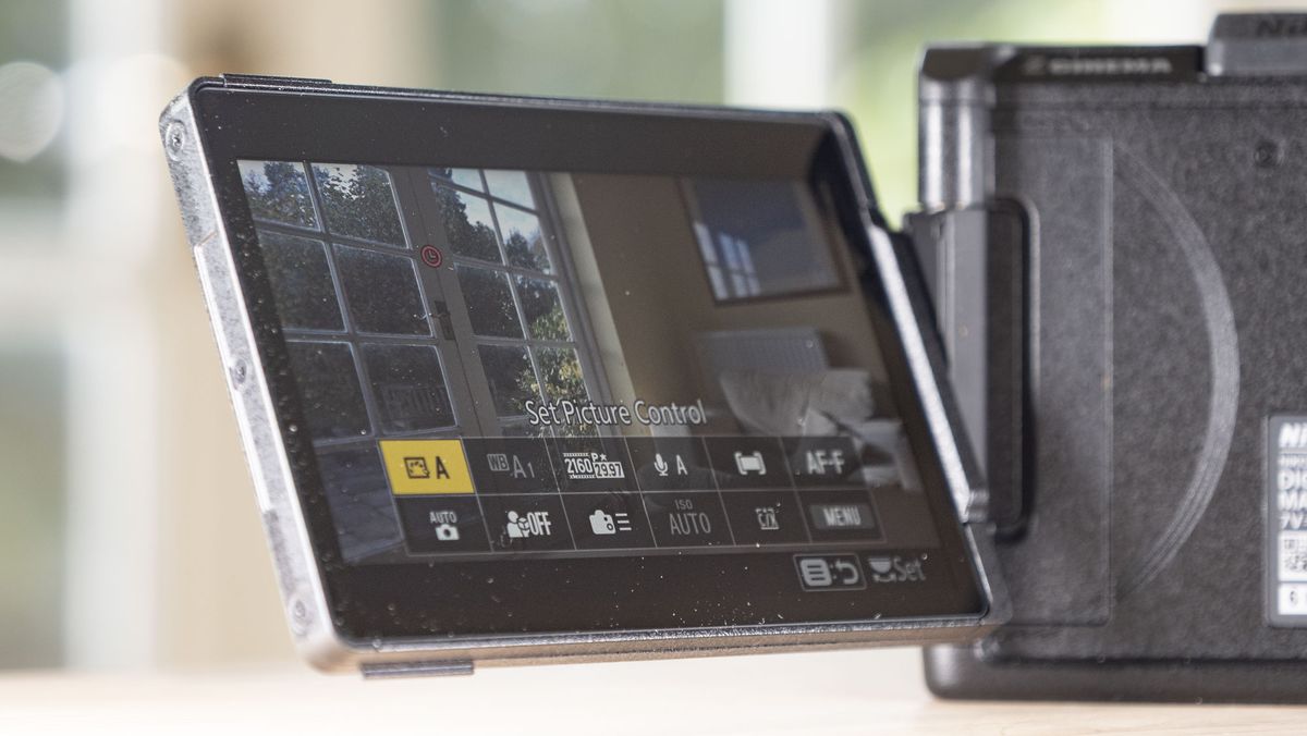 Nikon ZR product photos &ndash; camera on a wooden table, screen flipped out