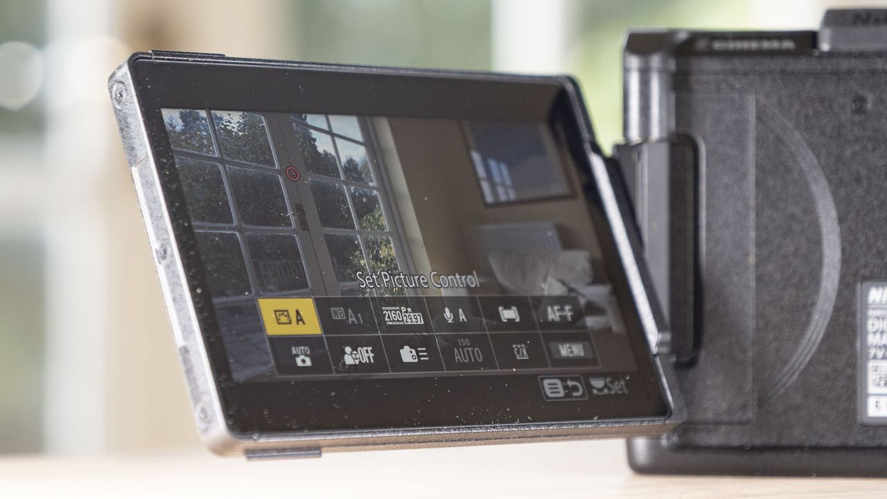Nikon ZR product photos &ndash; camera on a wooden table, screen flipped out