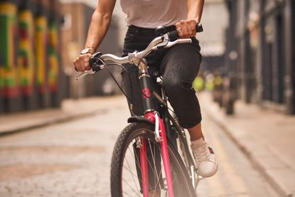 A person riding a Buzzbike in a city