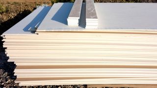 Pile of plasterboard sheets outside