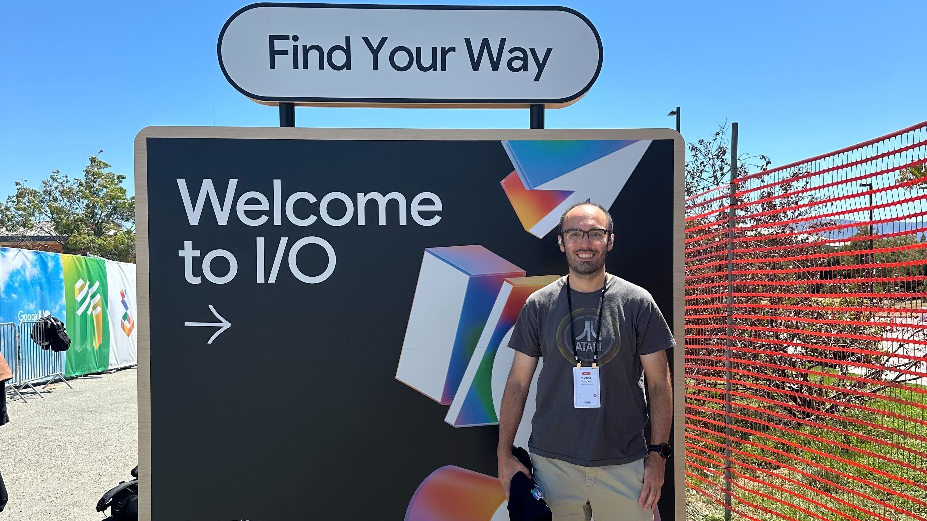 Michael standing in front of "Welcome to I/O" sign at I/O 2025