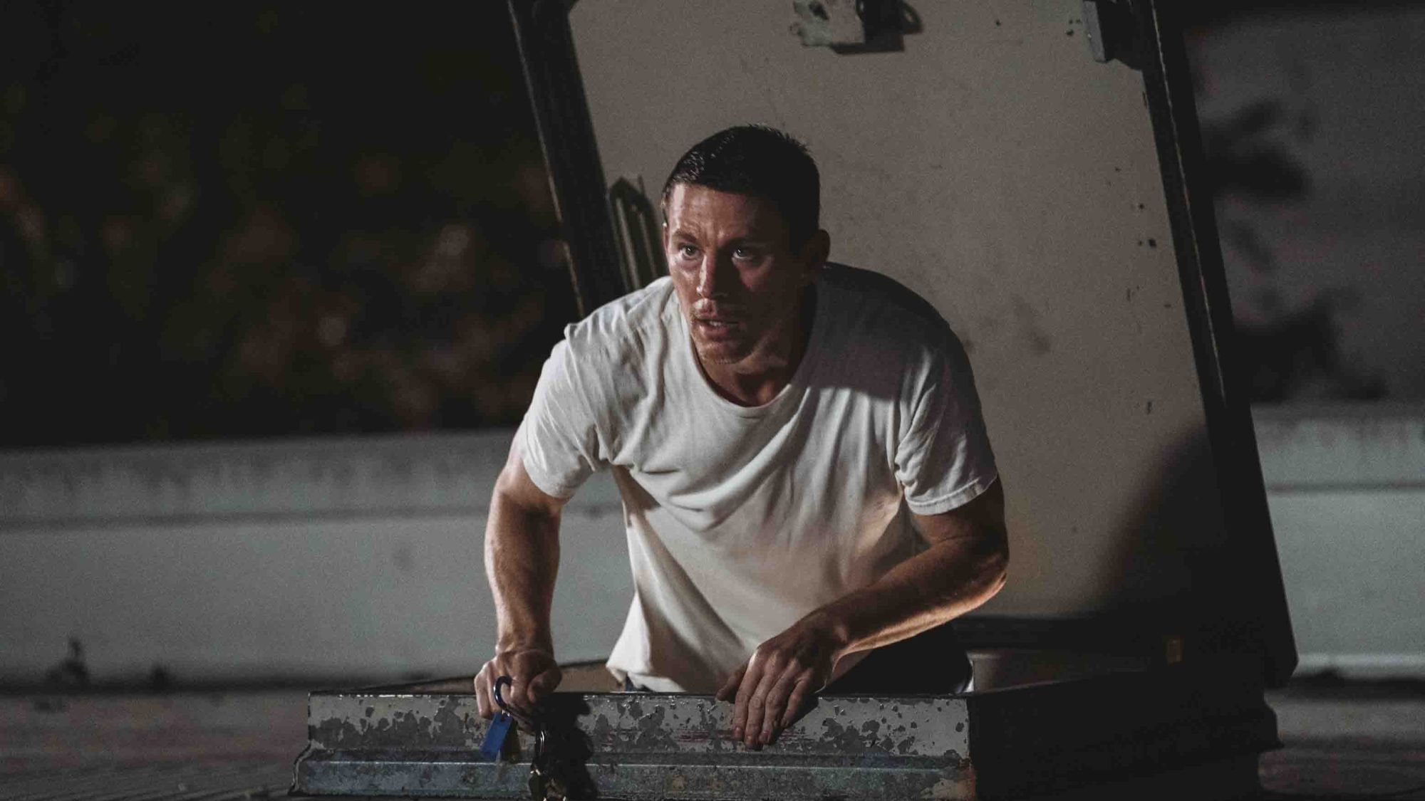 Channing Tatum coming out of a hatch on a roof in Roofman
