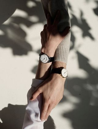 Two people holding hands with side by side Sekford watches