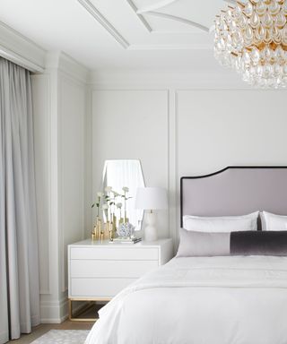 hotel bedroom with millwork and a neutral color scheme with curated side table