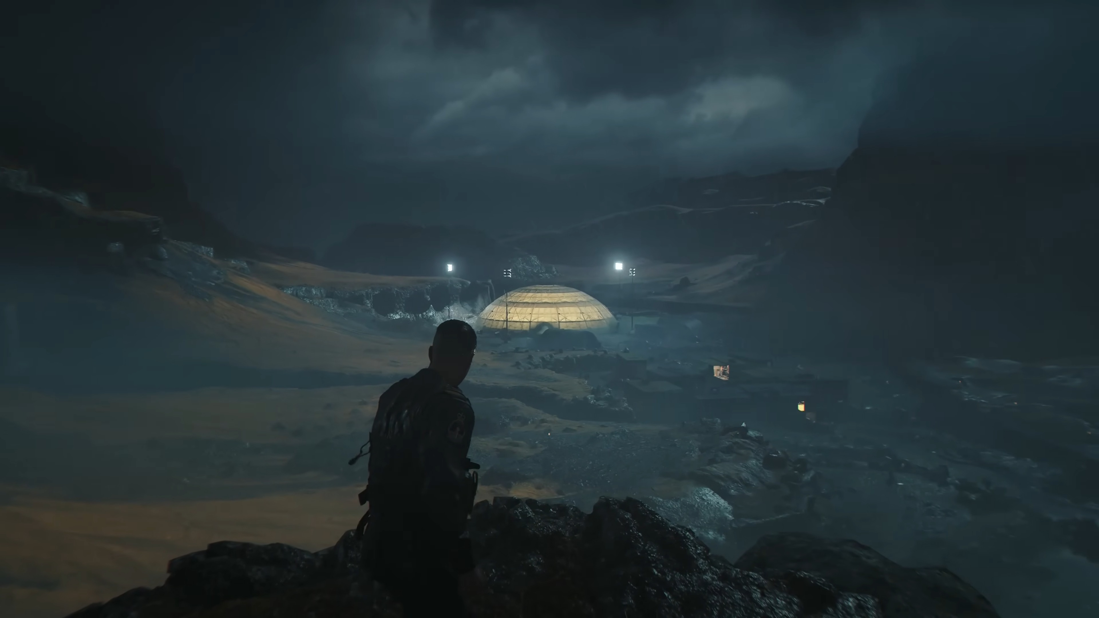 007 First Light James Bond on top of cliff in iceland looking at dome base