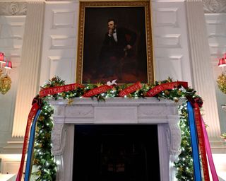 Ornaments can be seen on the mantle of the fireplace in the State Dining Room