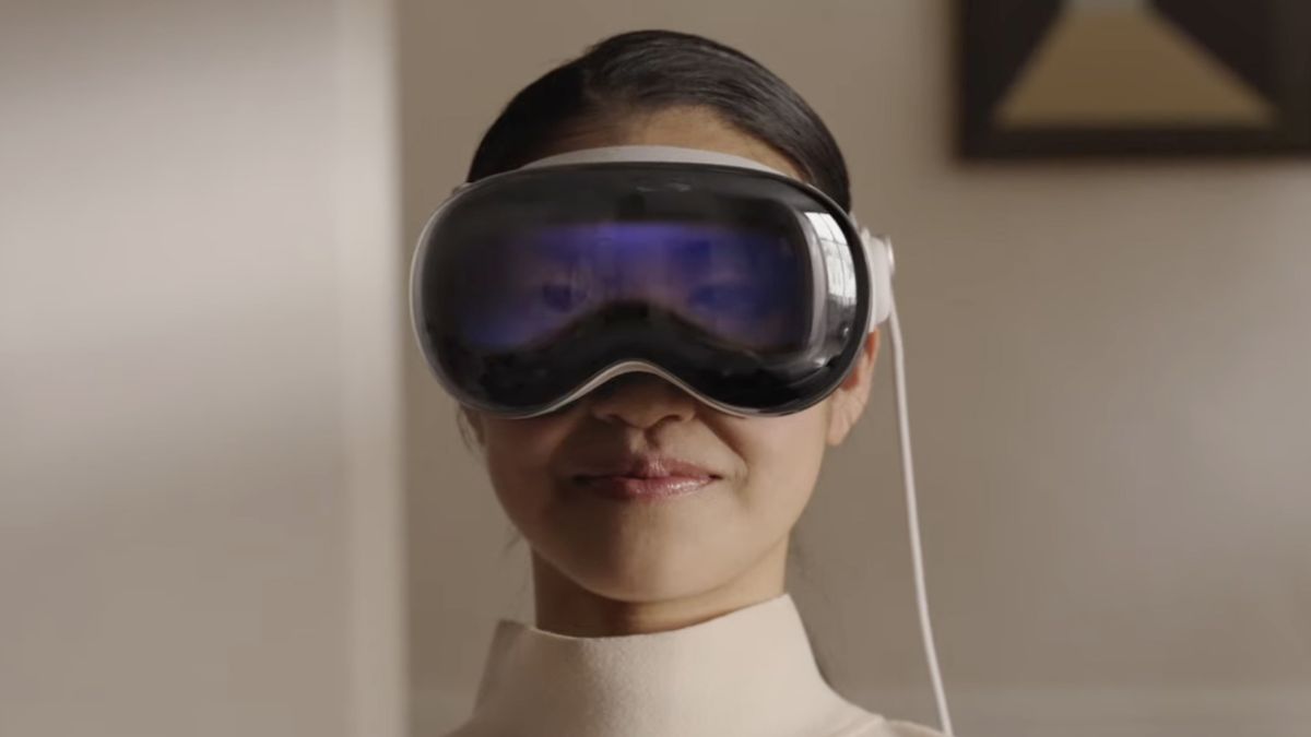 A woman wearing the Apple Vision Pro headset