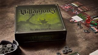 Disney Villainous promo shot with the box, tokens, and boards laid out on a table